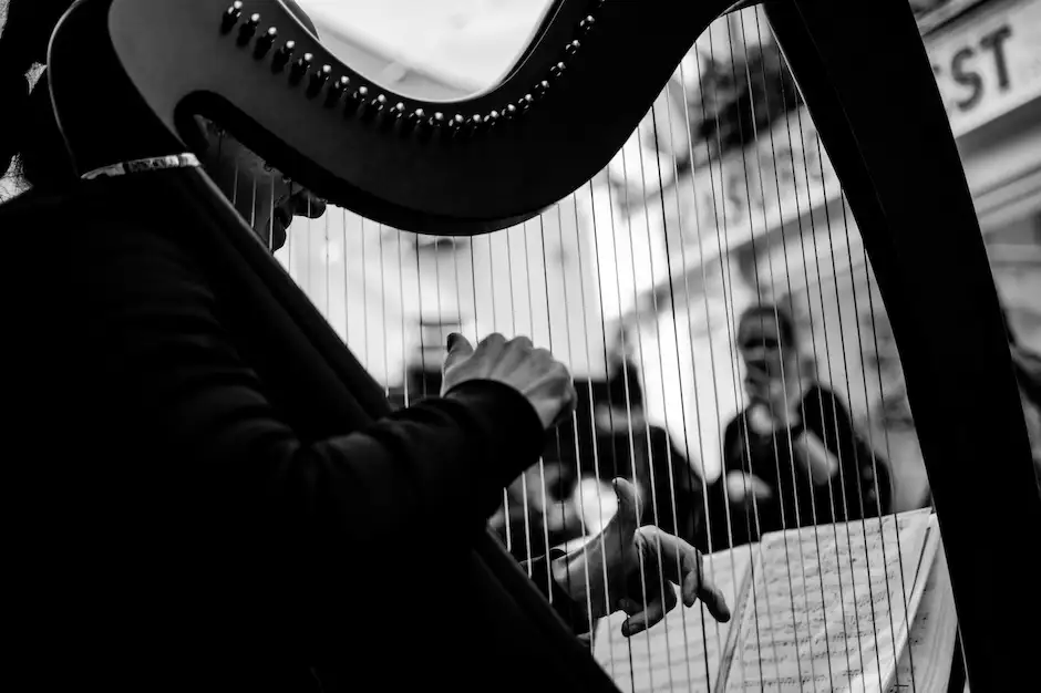 Black and white picture of harp being played